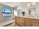 Main bathroom featuring dual sinks, modern fixtures, and a view of the pool at 1720 W Highland St, Chandler, AZ 85224