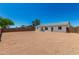 Large backyard featuring a white home exterior, gravel ground cover, and a block wall at 1727 W 12Th Ave, Apache Junction, AZ 85120