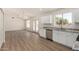 Open kitchen featuring new appliances, hardwood floors, and modern lighting at 1727 W 12Th Ave, Apache Junction, AZ 85120