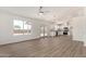 Spacious living room with an open layout featuring hardwood floors, natural light and modern light fixtures at 1727 W 12Th Ave, Apache Junction, AZ 85120