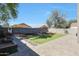 Paver patio and low-maintenance backyard features artificial turf and a fire pit, great for entertaining at 17426 W Calavar Rd, Surprise, AZ 85388
