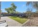 Paver patio leads to a backyard with artificial turf, rock landscaping, and an outdoor seating area at 17426 W Calavar Rd, Surprise, AZ 85388
