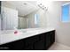 Bathroom featuring a white vanity, a mirror and a walk-in shower with glass doors at 17426 W Calavar Rd, Surprise, AZ 85388