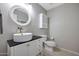 Powder room featuring vanity with vessel sink, framed mirror and toilet at 17426 W Calavar Rd, Surprise, AZ 85388