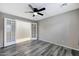 Bedroom with French doors, ceiling fan and gray flooring at 17426 W Calavar Rd, Surprise, AZ 85388