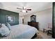 Bedroom featuring a ceiling fan, neutral carpet, and a decorative dresser at 17426 W Calavar Rd, Surprise, AZ 85388