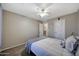 Serene bedroom with neutral walls, soft carpet, and a comfortable bed with a patterned blanket at 17426 W Calavar Rd, Surprise, AZ 85388