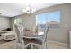 Dining room features a round table, decorative chairs and a large sunny window at 17426 W Calavar Rd, Surprise, AZ 85388