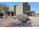Charming two-story home with a well-maintained yard and a red garage door at 17426 W Calavar Rd, Surprise, AZ 85388