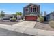 Charming two-story home with a well-maintained yard and a red garage door at 17426 W Calavar Rd, Surprise, AZ 85388