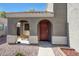 Inviting front porch with a cozy wooden bench and an arched entryway at 17426 W Calavar Rd, Surprise, AZ 85388