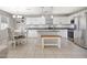 Spacious kitchen with white cabinets, stainless steel appliances and a granite island at 17426 W Calavar Rd, Surprise, AZ 85388
