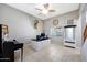Well-lit office space featuring a desk, ceiling fan, and neutral decor at 17426 W Calavar Rd, Surprise, AZ 85388