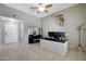 Well-lit office space featuring a desk, ceiling fan, and neutral decor at 17426 W Calavar Rd, Surprise, AZ 85388
