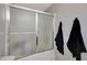 Walk-in shower with glass doors and black towels hanging on the wall at 17426 W Calavar Rd, Surprise, AZ 85388