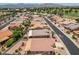 An aerial view of a residential neighborhood with mountains in the distance and lush golf course nearby at 17805 W Arizona Dr, Surprise, AZ 85374