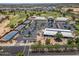 A high angle of the clubhouse, tennis courts, and golf course offering a peek into community amenities at 17805 W Arizona Dr, Surprise, AZ 85374