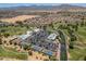 A high angle of the community with golf course, clubhouse, pool, and tennis courts against mountain backdrop at 17805 W Arizona Dr, Surprise, AZ 85374