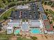 Birds eye view of the clubhouse and tennis courts surrounded by lush golf courses and mature landscaping at 17805 W Arizona Dr, Surprise, AZ 85374