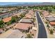 An aerial view of a residential neighborhood with mountains in the distance and lush golf course nearby at 17805 W Arizona Dr, Surprise, AZ 85374