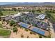 An elevated view of the tennis courts and community center amidst a golf course setting with mountain views at 17805 W Arizona Dr, Surprise, AZ 85374