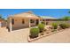 Landscaped backyard with manicured bushes, gravel cover, and privacy wall at 17805 W Arizona Dr, Surprise, AZ 85374