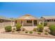Back of house with covered patio and serene, low-maintenance landscaped yard at 17805 W Arizona Dr, Surprise, AZ 85374