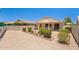 A cozy backyard featuring a covered patio and desert landscaping with a brick-lined garden area at 17805 W Arizona Dr, Surprise, AZ 85374