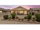 A cozy backyard featuring a covered patio and a charming desert landscape with green shrubs at 17805 W Arizona Dr, Surprise, AZ 85374