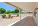 Covered backyard patio providing an outdoor living space overlooking a landscaped yard at 17805 W Arizona Dr, Surprise, AZ 85374