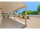 Covered backyard patio providing an outdoor living space overlooking a landscaped yard at 17805 W Arizona Dr, Surprise, AZ 85374