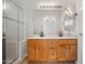 Bathroom featuring a double vanity with wood cabinets, quartz countertops, and a large mirror at 17805 W Arizona Dr, Surprise, AZ 85374