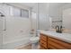 Well-lit bathroom with a shower-tub combination and wooden vanity at 17805 W Arizona Dr, Surprise, AZ 85374