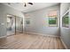 Bedroom with sliding closet doors, wood floors, light gray walls, and natural light at 17805 W Arizona Dr, Surprise, AZ 85374