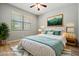 A staged bedroom with a large bed, soft rug, and a window with natural light at 17805 W Arizona Dr, Surprise, AZ 85374