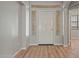 Inviting entryway featuring a white front door with decorative sidelights and wood-look flooring at 17805 W Arizona Dr, Surprise, AZ 85374