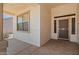 Covered front porch featuring neutral stucco and patterned concrete flooring at 17805 W Arizona Dr, Surprise, AZ 85374