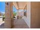 Covered front porch featuring neutral stucco and patterned concrete flooring at 17805 W Arizona Dr, Surprise, AZ 85374