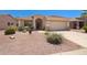 Inviting single-Gathering home featuring desert landscaping, arched entryway, and two-car garage at 17805 W Arizona Dr, Surprise, AZ 85374