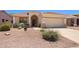 Inviting single-Gathering home featuring desert landscaping, arched entryway, and two-car garage at 17805 W Arizona Dr, Surprise, AZ 85374