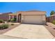 Inviting single-Gathering home featuring desert landscaping, arched entryway, and two-car garage at 17805 W Arizona Dr, Surprise, AZ 85374