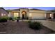 Inviting single-Gathering home featuring desert landscaping, arched entryway, and two-car garage at 17805 W Arizona Dr, Surprise, AZ 85374
