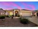 Inviting single-Gathering home featuring desert landscaping, arched entryway, and two-car garage at 17805 W Arizona Dr, Surprise, AZ 85374