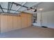 Well-organized garage with plenty of storage cabinets, speckled epoxy flooring, and an automatic door opener at 17805 W Arizona Dr, Surprise, AZ 85374