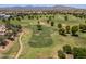 Picturesque golf course featuring lush green fairways, mature trees, and mountain views in the background at 17805 W Arizona Dr, Surprise, AZ 85374