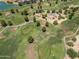 Wide aerial shot of a golf course featuring intricate pathways, mature trees, and carefully manicured greens at 17805 W Arizona Dr, Surprise, AZ 85374