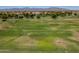 Expansive view of a verdant golf course with rolling hills, mature trees, and open fairways under a sunny sky at 17805 W Arizona Dr, Surprise, AZ 85374