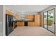 Kitchen with wood cabinets, black appliances, and a sliding glass door to the outside at 17805 W Arizona Dr, Surprise, AZ 85374