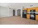 Spacious kitchen with wood cabinets and black appliances at 17805 W Arizona Dr, Surprise, AZ 85374