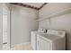 Bright laundry room with modern washer and dryer, shelving and convenient access at 17805 W Arizona Dr, Surprise, AZ 85374